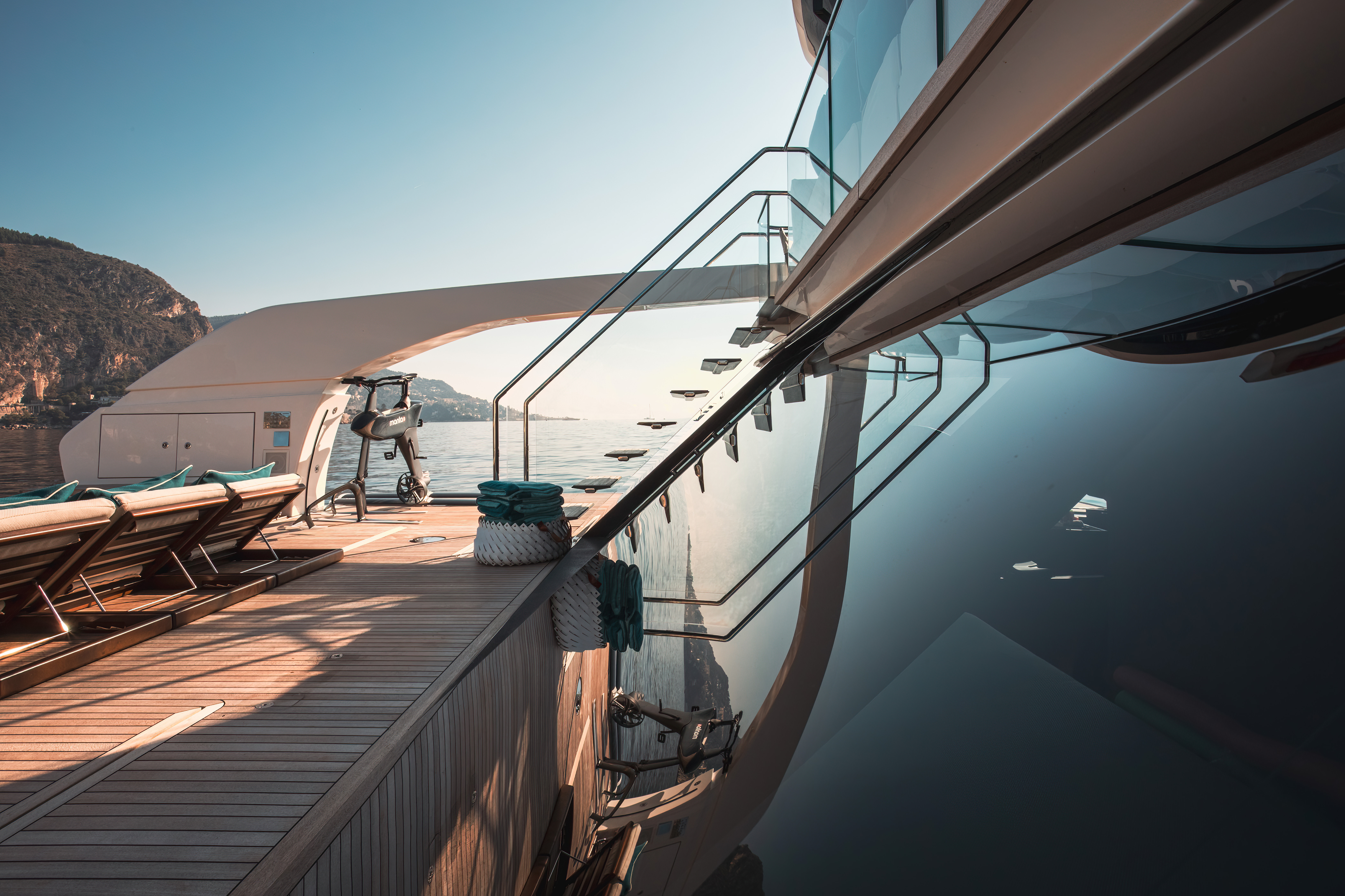 Deck of a superyacht with reflected staircase